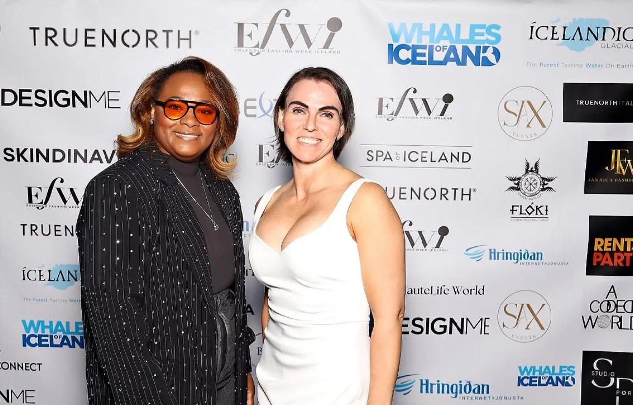 Nathalia at a fashion event, wearing orange glasses and a black pinstripe jacket